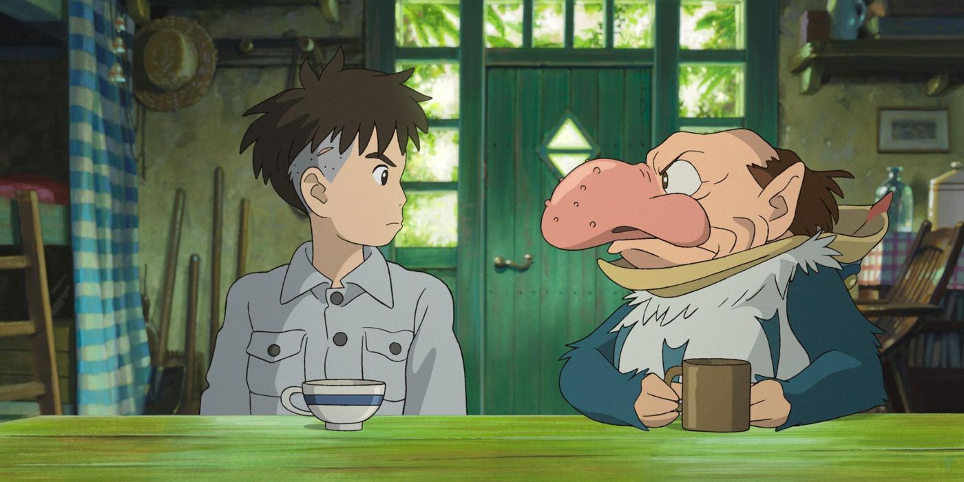 Two characters sit at a table in The Boy and the Heron