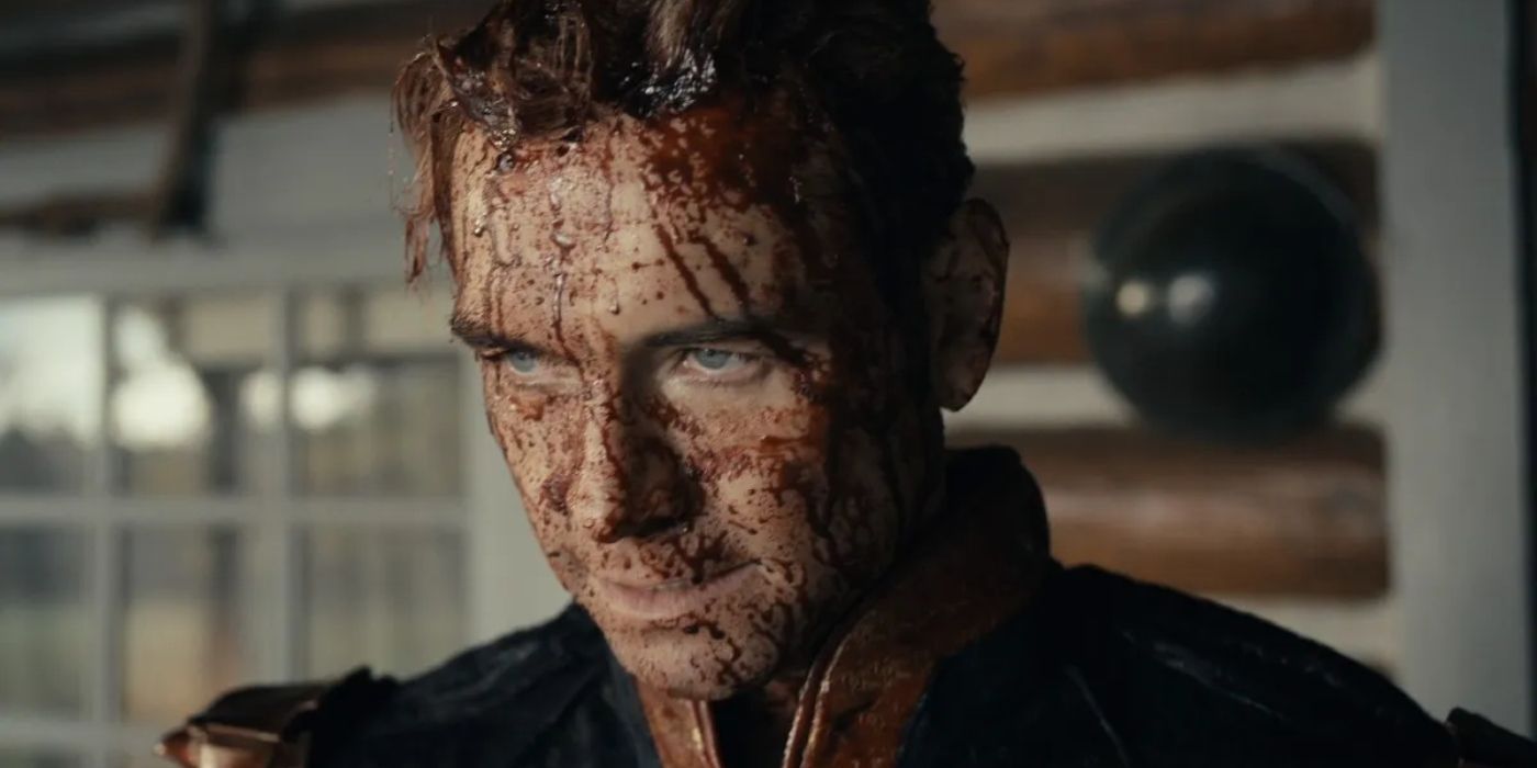 Antony Starr as Homelander in The Boys covered in blood all over his face while standing outside a house