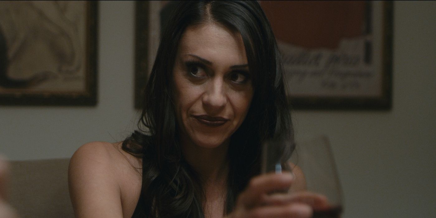 Tara Milante holding a wine glass at dinner in The Evil Down the Street 2019