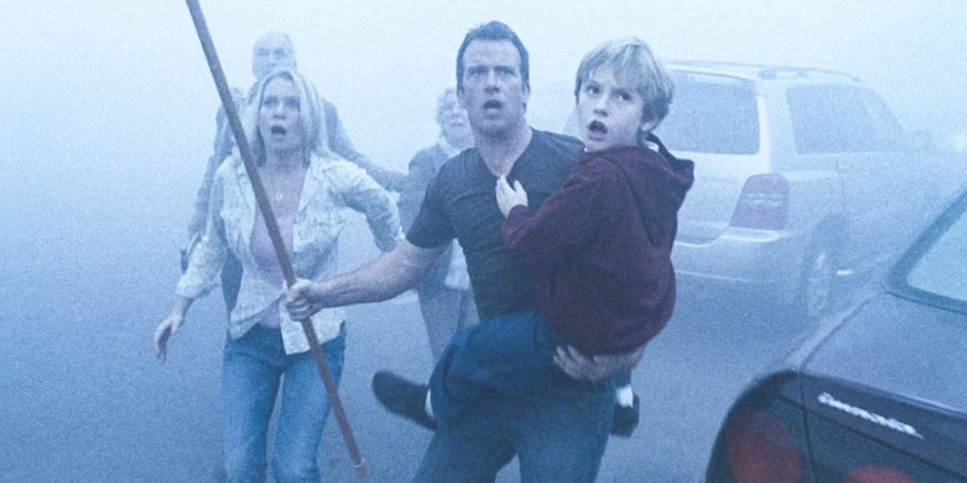 A father carries his son as he leads a small group through a heavy mist, armed with a rod.