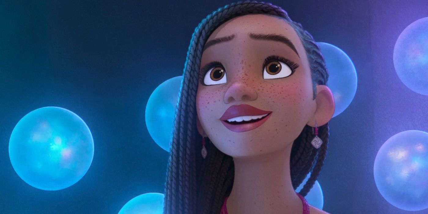 Ariana DeBose as Asha in Disney's Wish, looking at glowing orbs.