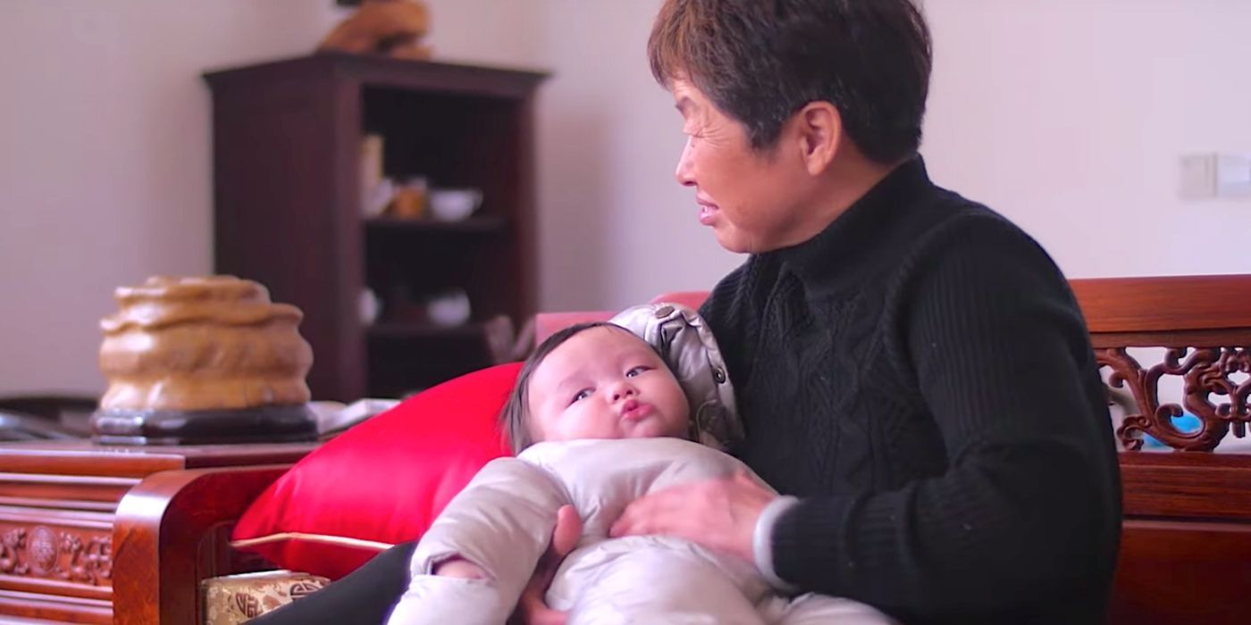 A woman holding a baby in a scene from the documentary One Child Nation.