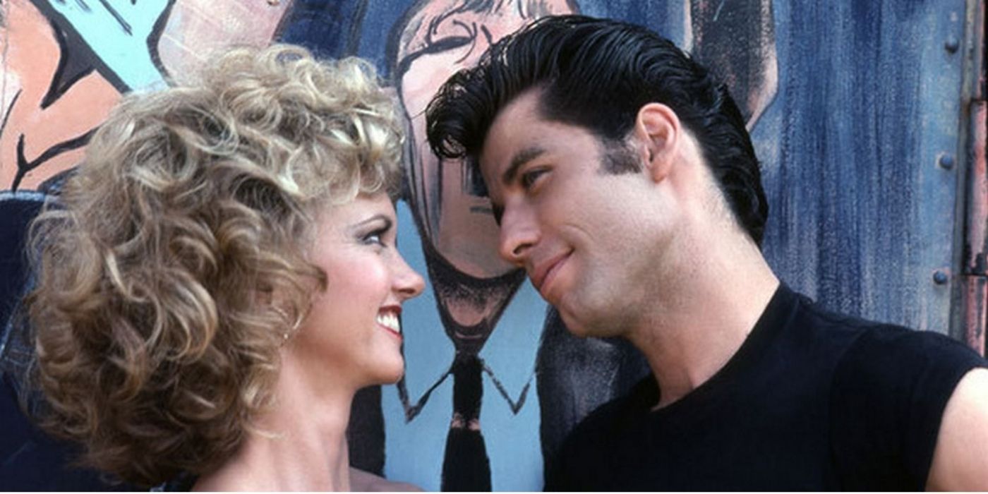 John Travolta and Olivia Newton-John looking at each other