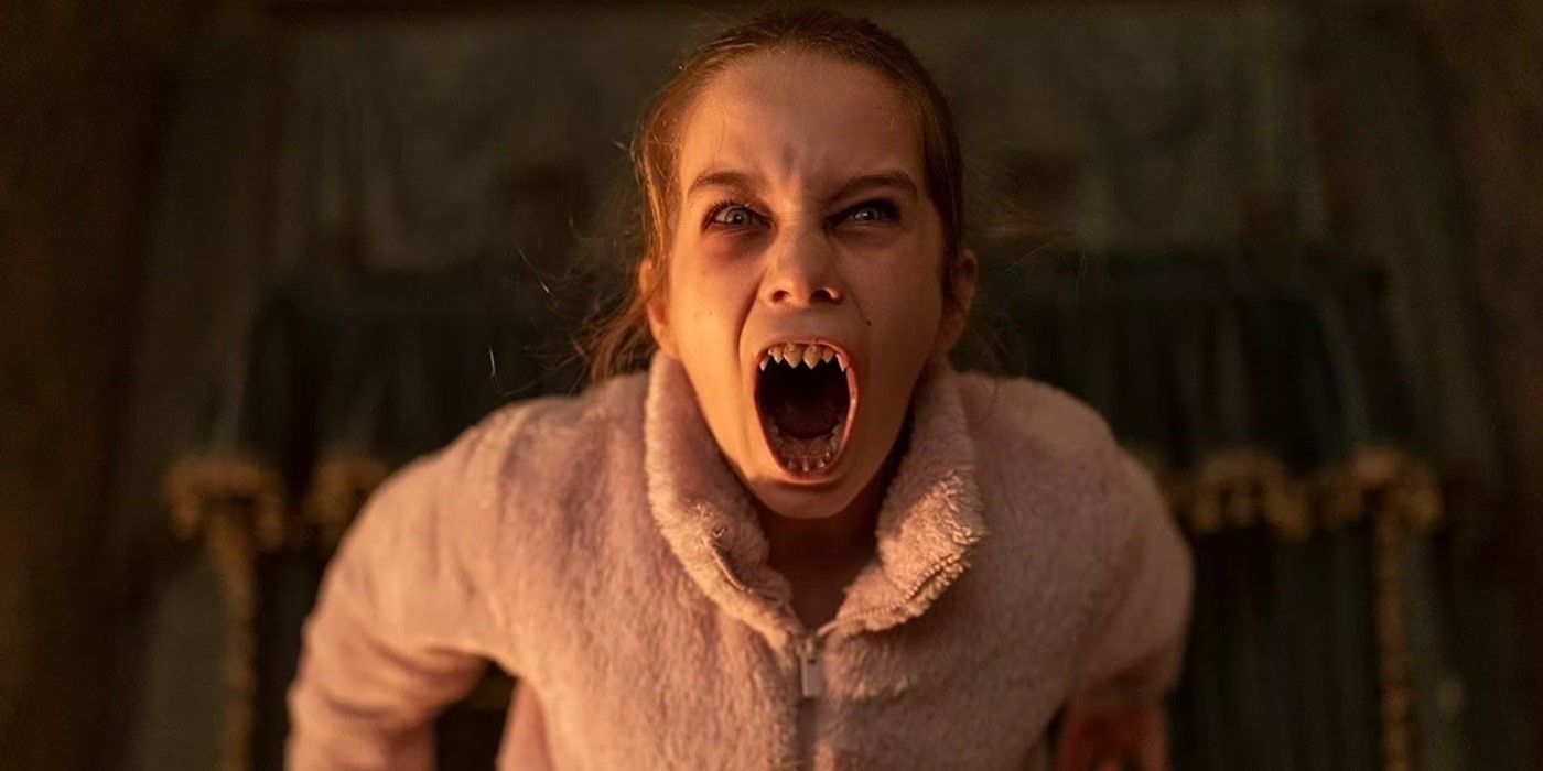 Alisha Weir screaming at the camera with fanged teeth as Abigail in Abigail