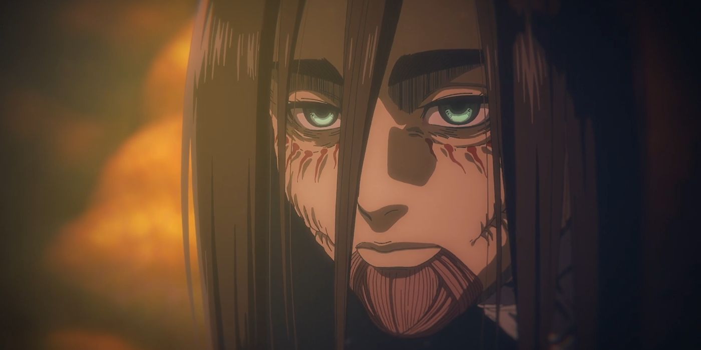 A close-up of Eren in Attack on Titan, with long hair and green eyes