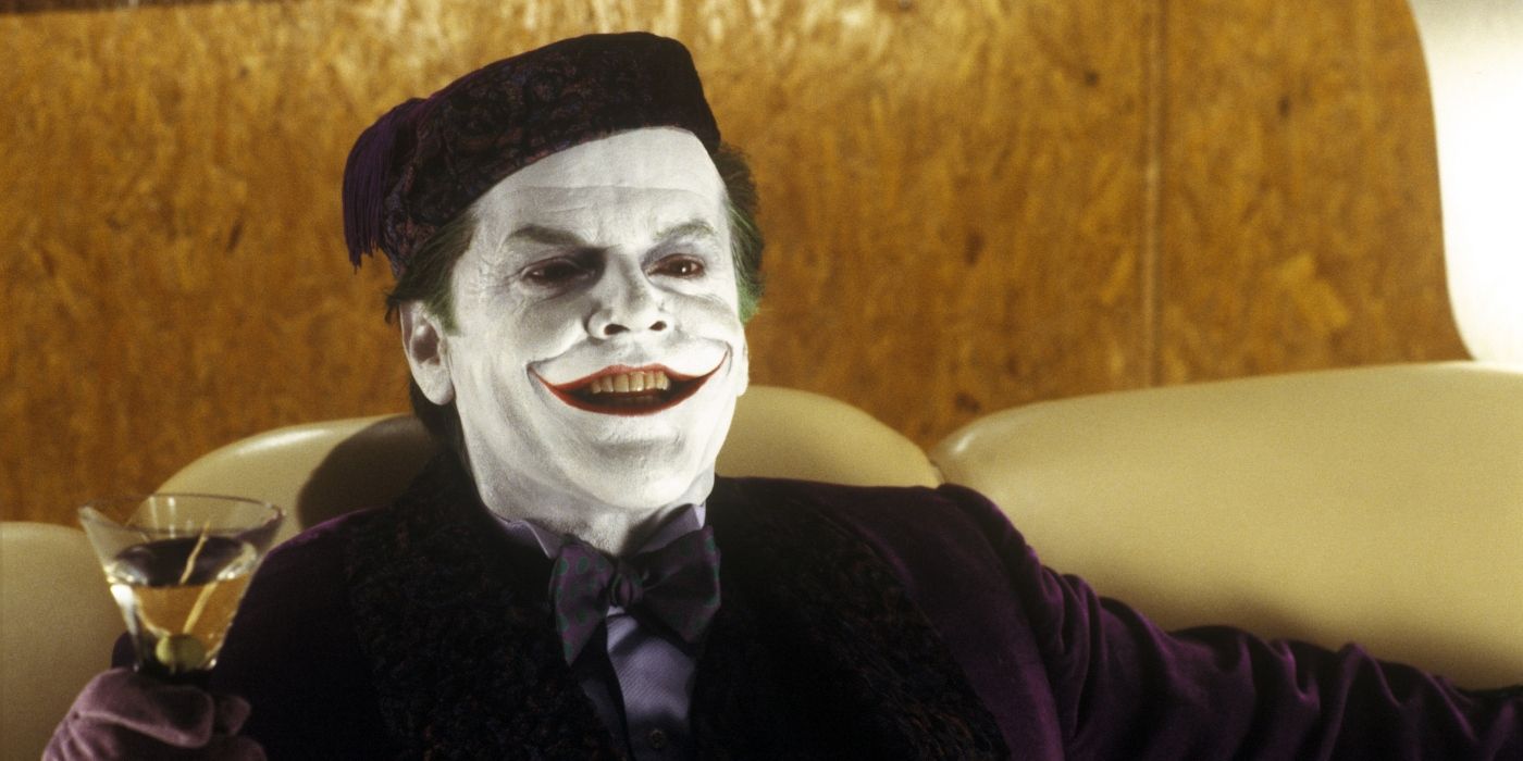 the joker smiles as he has a drink in the film batman from 1989