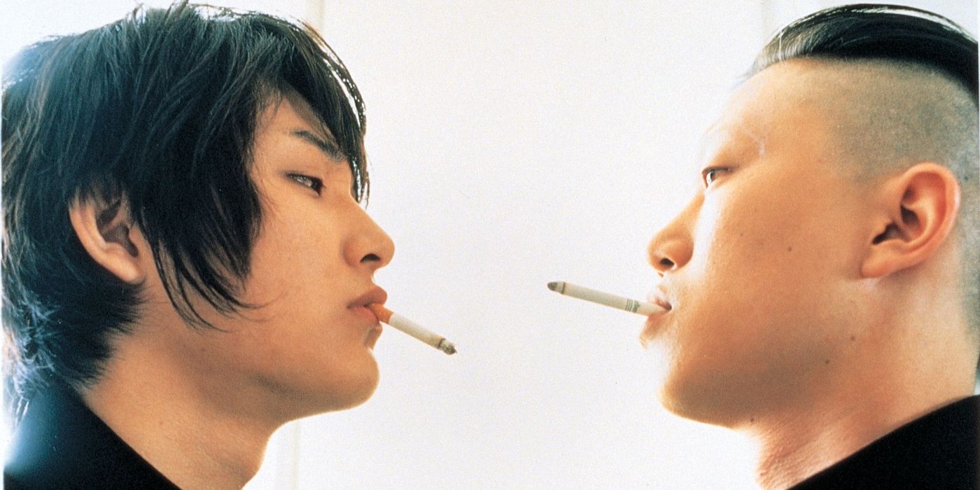 Blue Spring 2001 two teens stare at each other while smoking cigarettes
