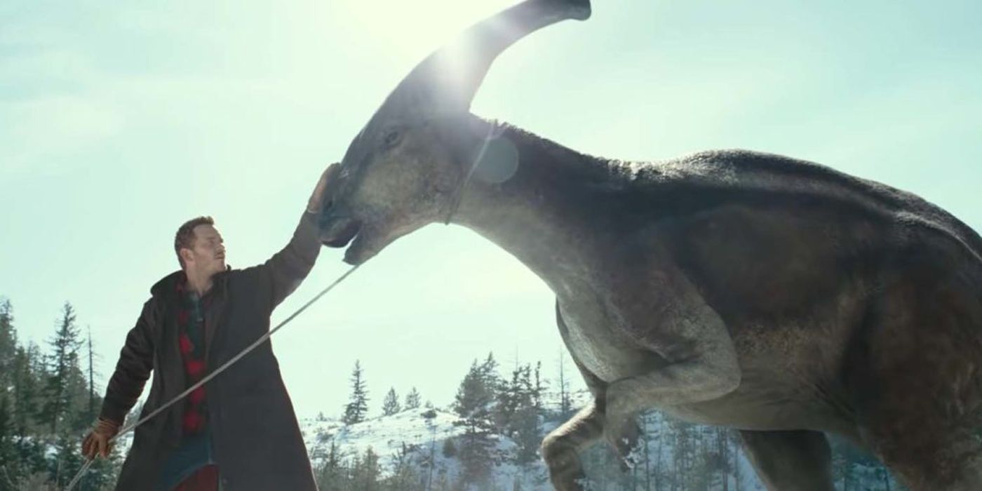 Chris Pratt as Owen Grady petting a dinosaur in Jurassic World: Dominion