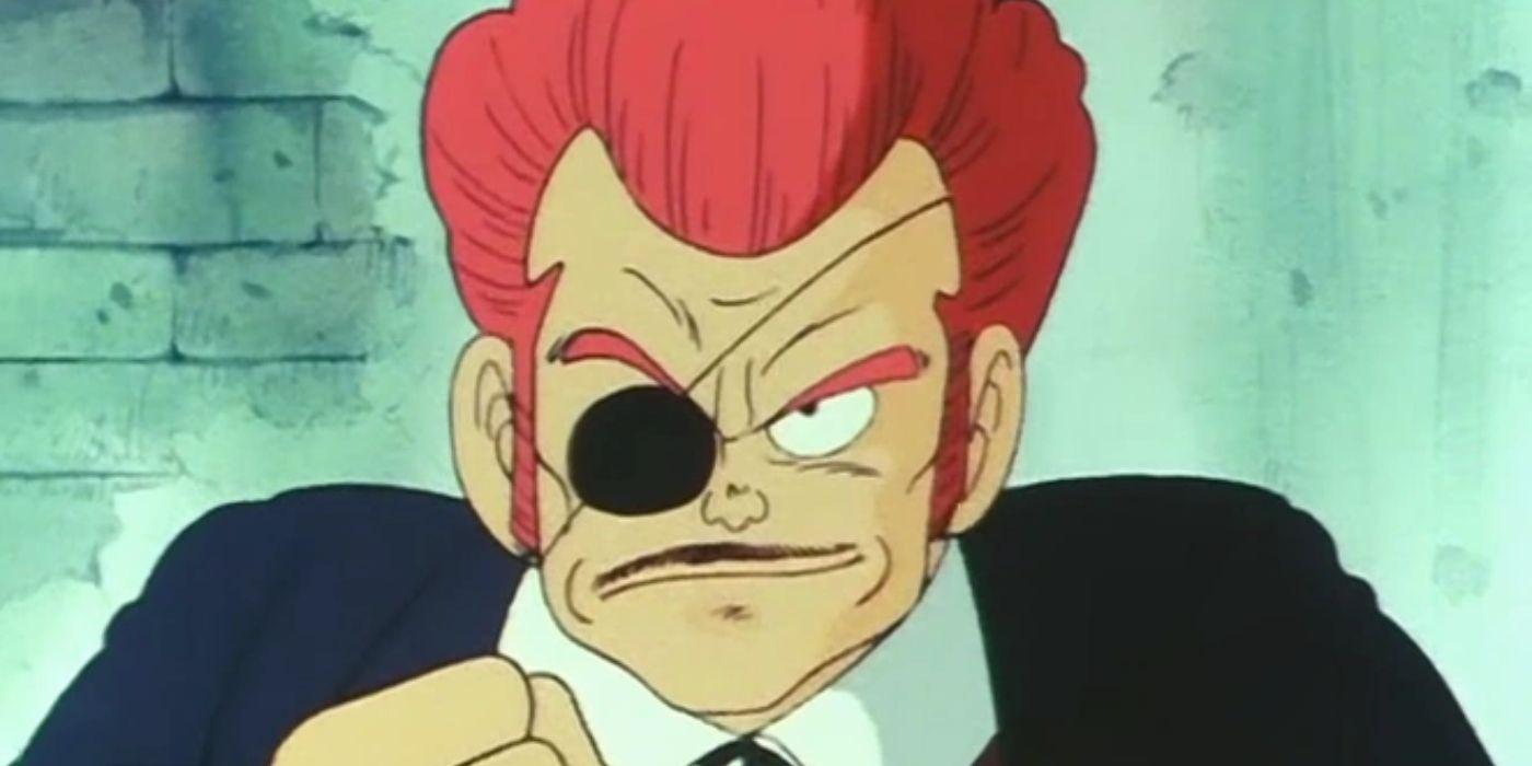 A close-up of a red-haired man in a suit, with an eye-patch and mustache, in Dragon Ball