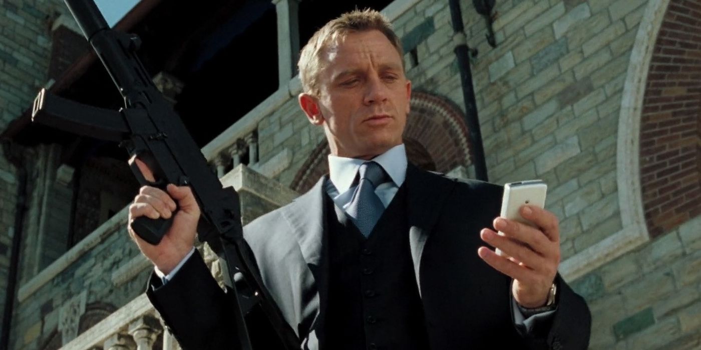 Daniel Craig as James Bond in Casino Royale (2006) looking at a small phone