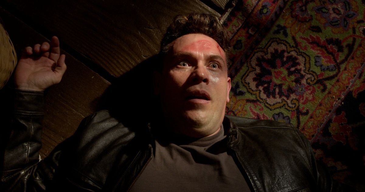 Kevin Alejandro as Daniel Espinoza, looking bewildered as he lies on a rug