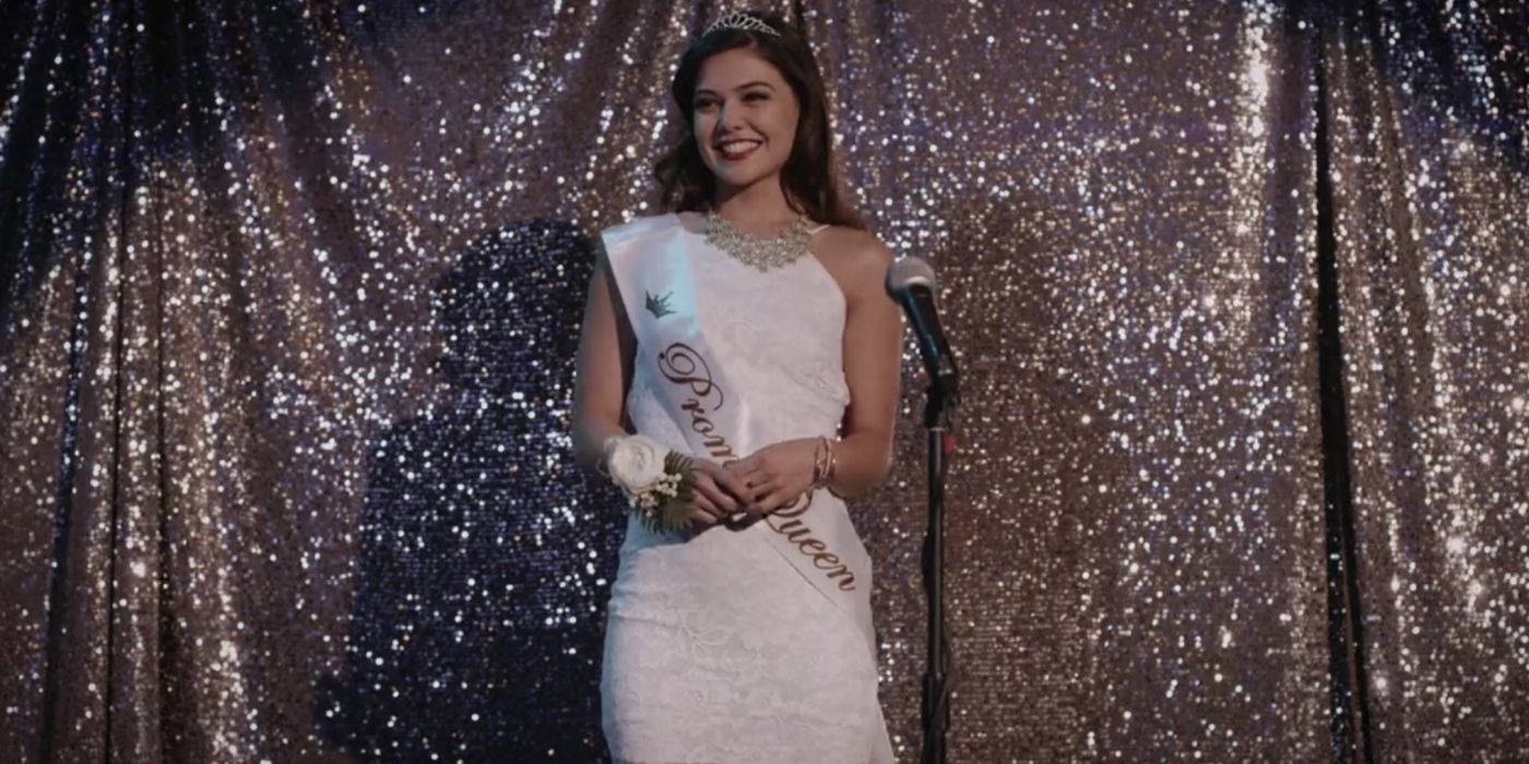 Danielle Campbell as Maddy, wearing a white dress and sash that says 