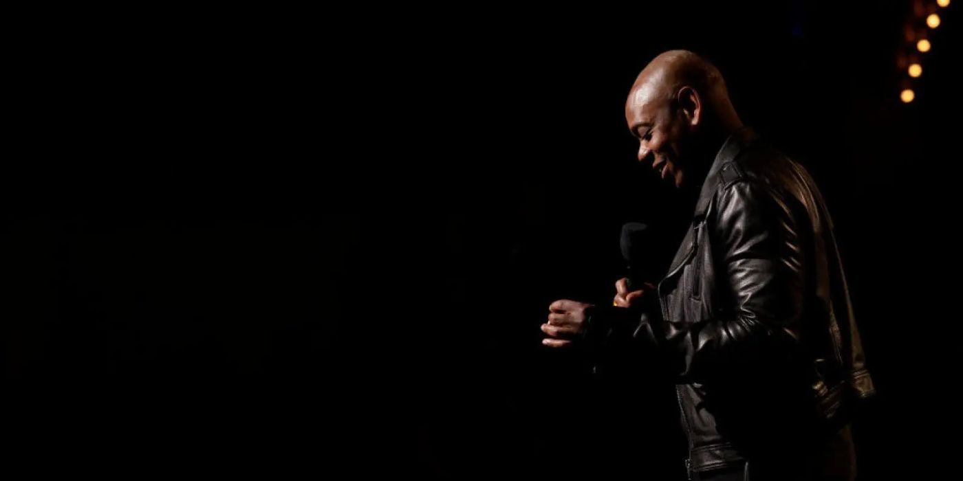 Dave Chappelle does stand-up in The Dreamer with a black background