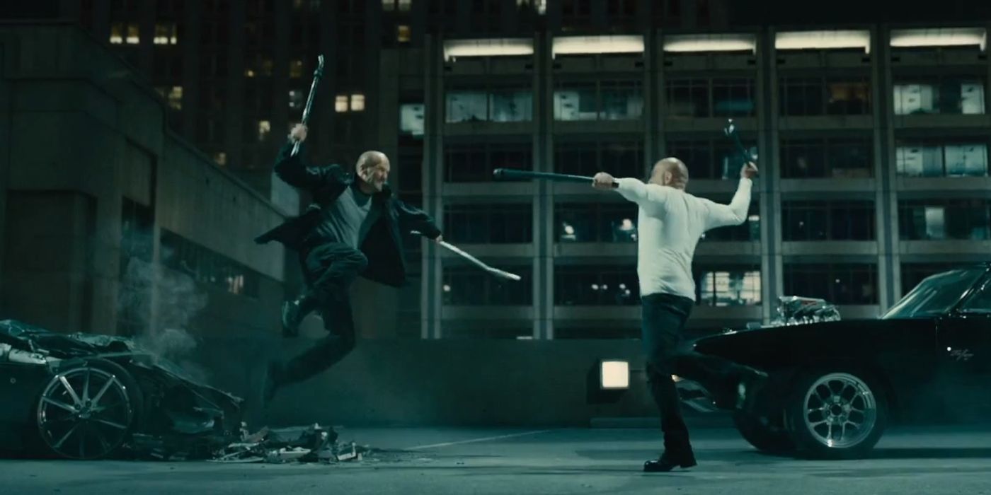 Jason Statham as Deckard Shaw leaps into the air, ready to swing pipes at Vin Diesel as Dominic Toretto