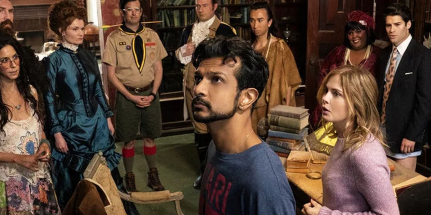 Rose McIver and Utkarsh Ambudkar as Samantha and Jay with the main cast of ghosts behind them in Ghosts