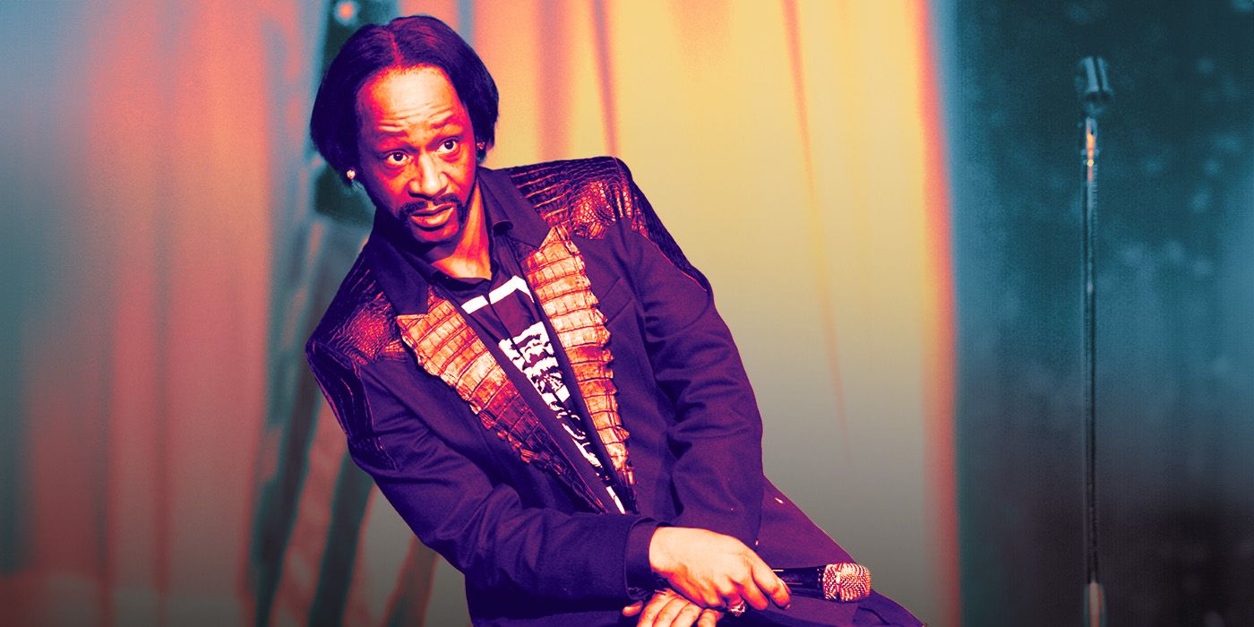 Katt Williams performing a stand-up comedy routine wearing a suit and holding a microphone on stage