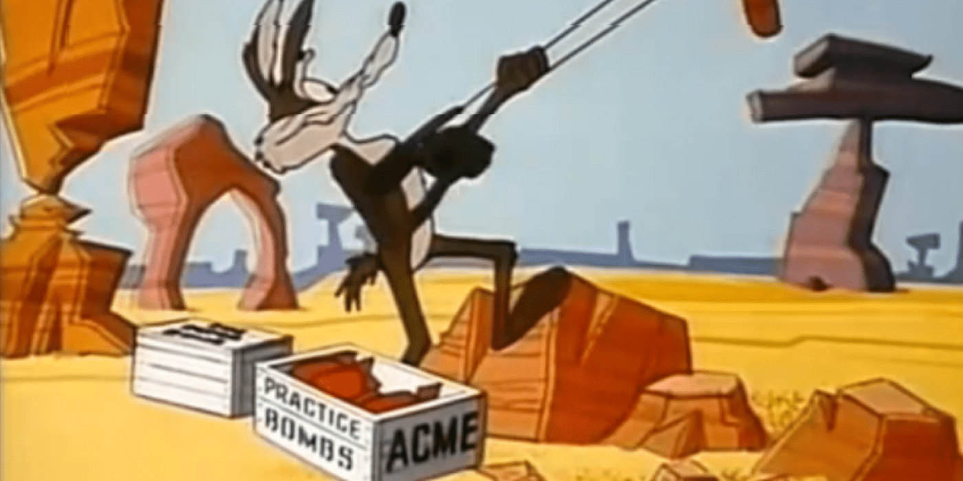 Wile E Coyote is pulled back in a slingshot. Two boxes are at his feet labled Came and practice bombs.