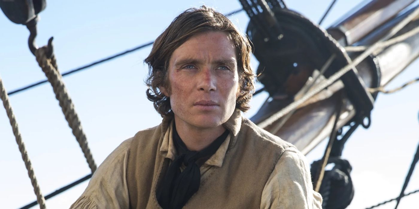 Cillian Murphy as a sailor named Matthew Joy sitting on his boat in In the Heart of the Sea
