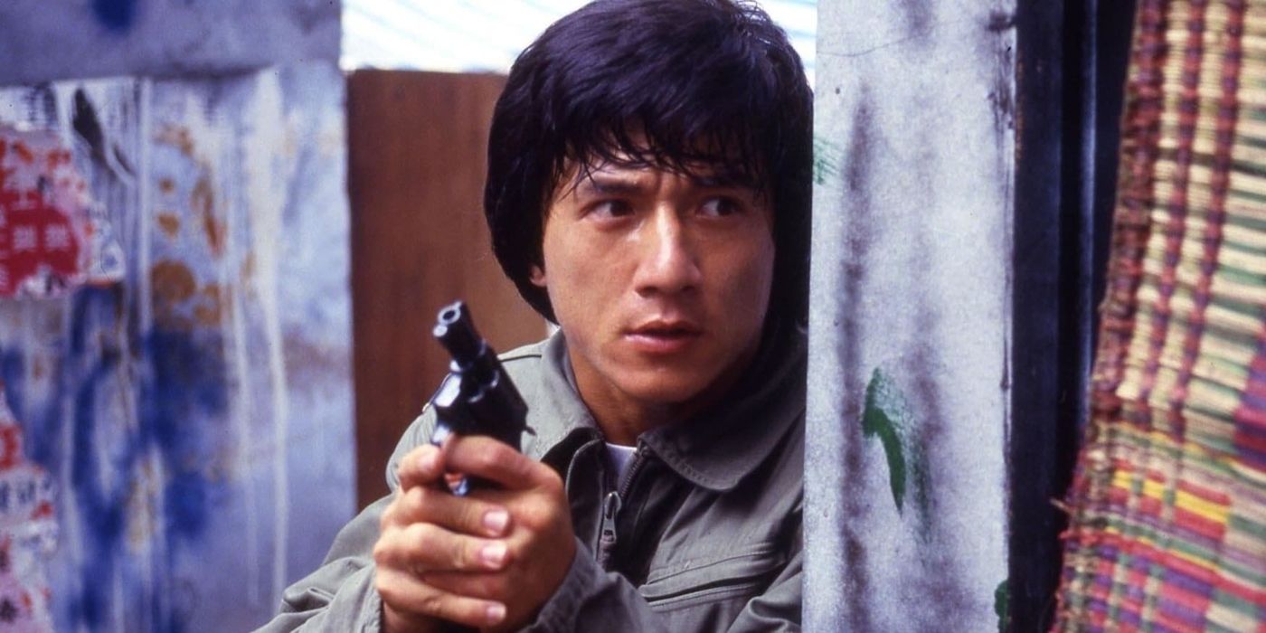 Jackie Chan as Chan Ka-Kui holding a small pistol leaning against a wall in Police Story (1985)