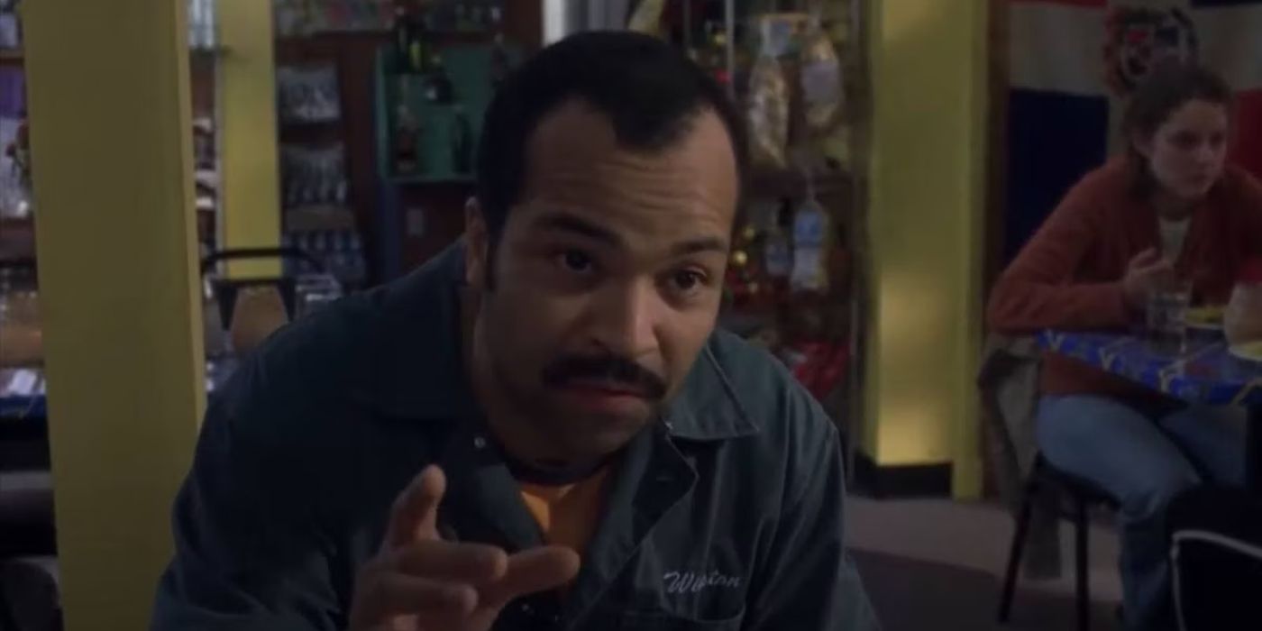Jeffrey Wright, in character as Winston, sits a dining table during an indoor scene from Broken Flow
