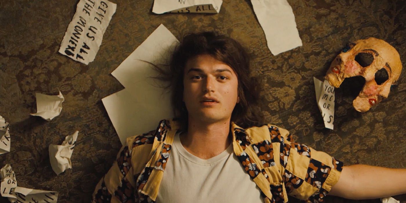 Joe Keery in the movie Marmalade surrounded by paper and a mask