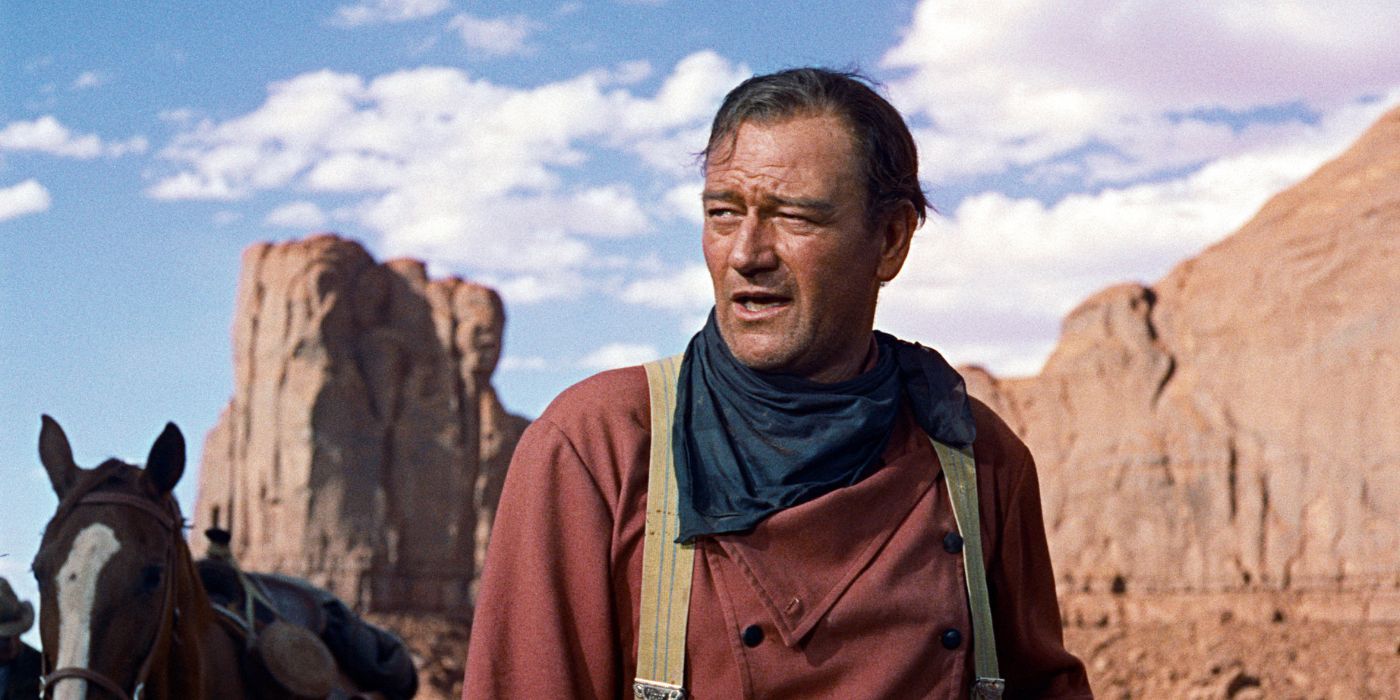 John Wayne as Ethan Edwards standing without his hat in the desert in The Searchers