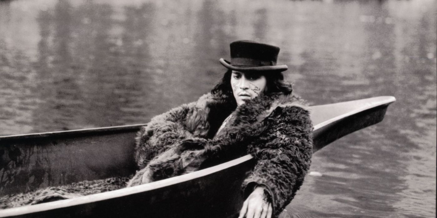 Johnny Depp as William Blake, wearing a fur coat and top hat while lying in a canoe in Dead Man