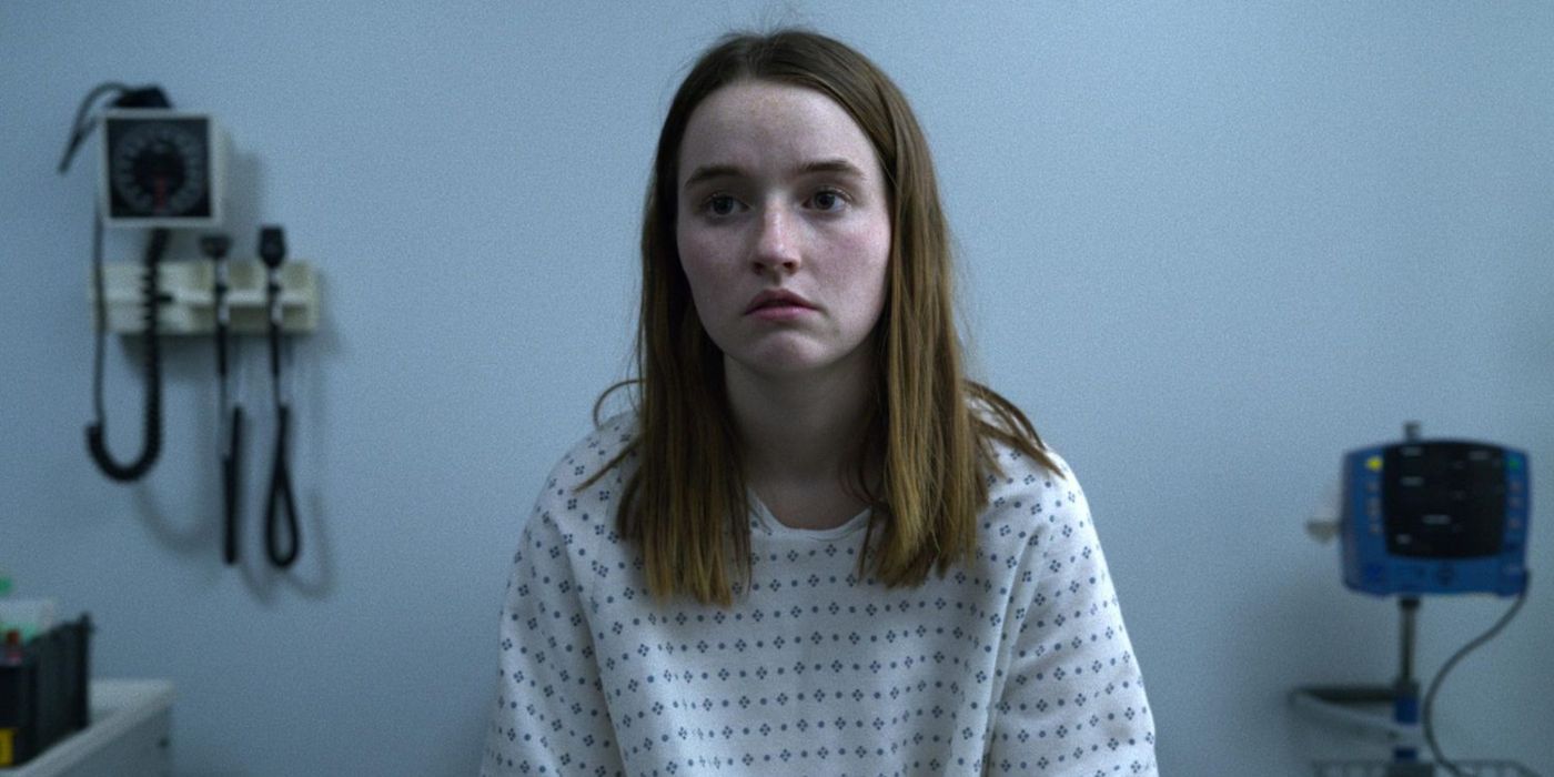 Kaitlyn Dever as Marie Adler in a hospital gown talking to a nurse off-screen in Unbelievable