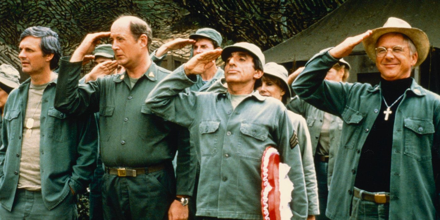 The cast of M*A*S*H saluting in uniform