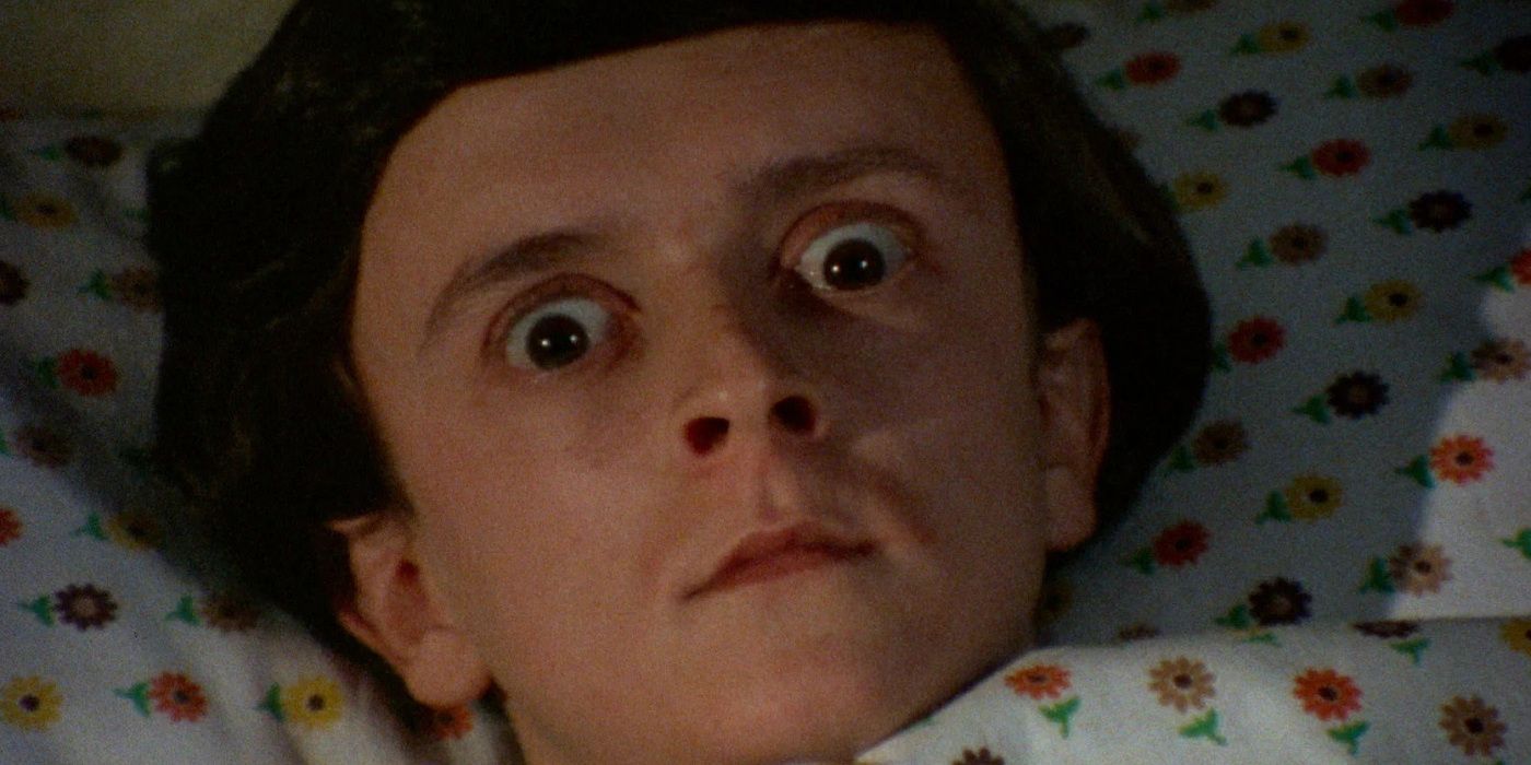 Dwarf actor Peter Bark as the child Michael, lying in bed with eyes wide