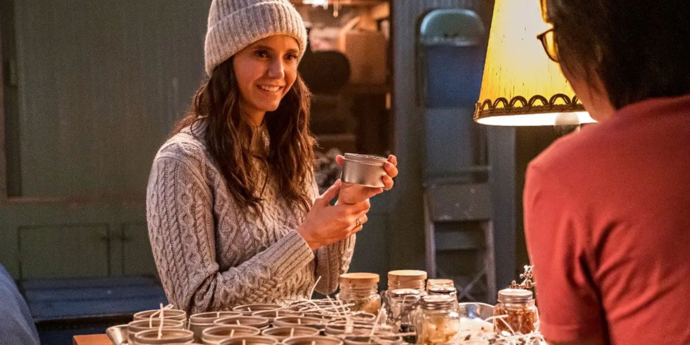 Nina Dobrev in Love Hard holding candle