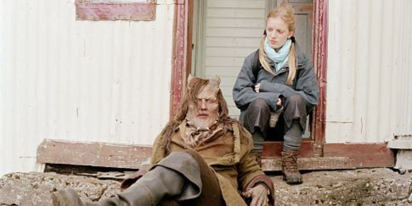 Sarah Polley as Beatrice sitting on a porch with Robert John Burke as The Monster