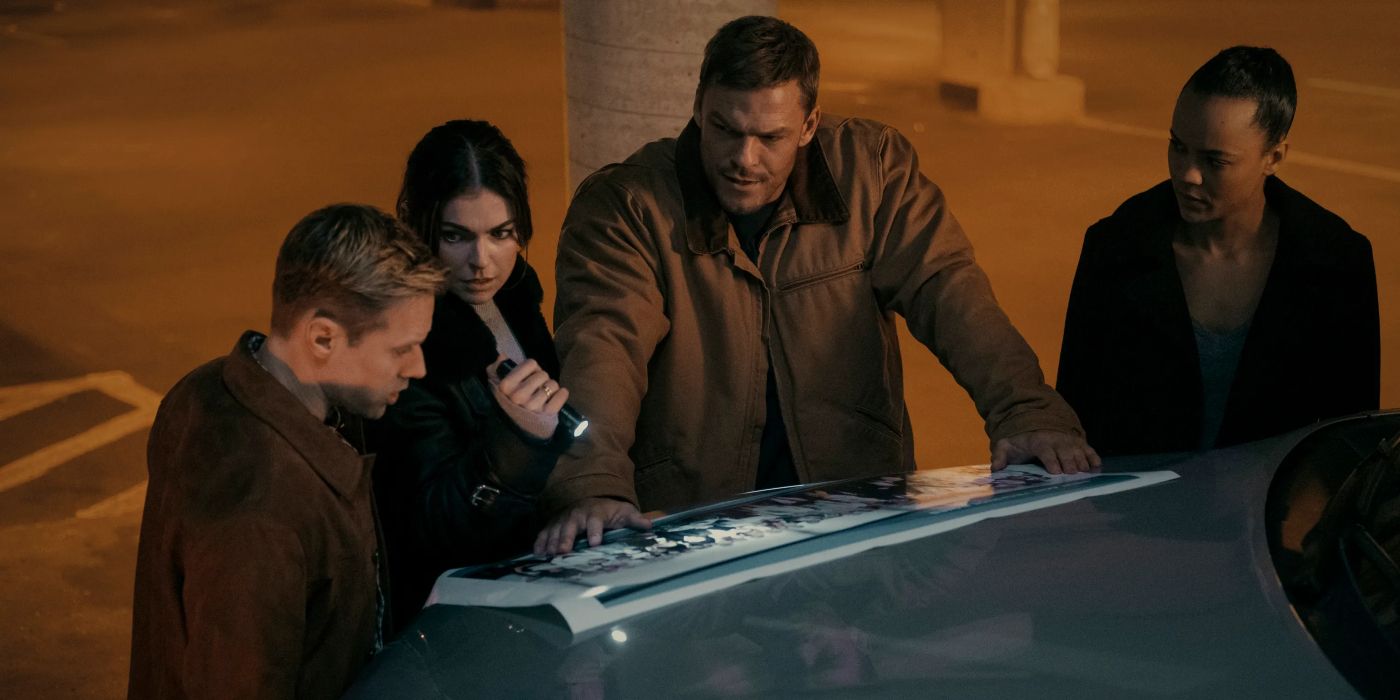 Alan Ritchson, Shaun Sipos, Serinda Swan, and Maria Sten looking at something with a flashlight in Reacher