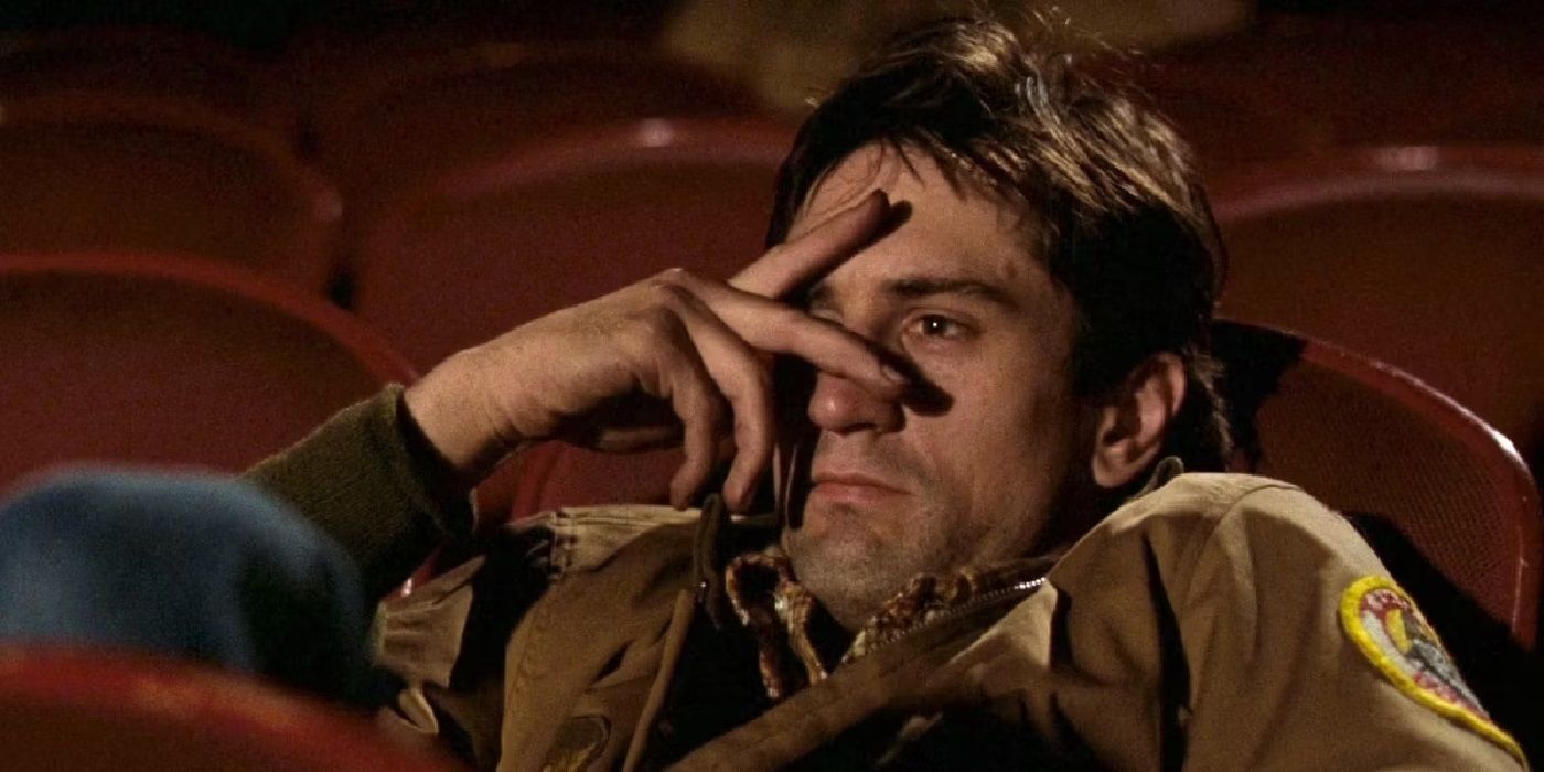 Robert DeNiro as Travis Bickle with fingers over his eyes in a scene from Taxi Driver