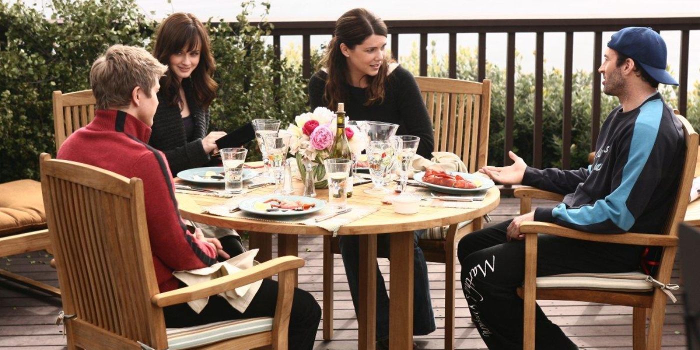 Rory, Logan, Lorelai, and Luke in Gilmore Girls, all sitting at a table Valentine's Day episode