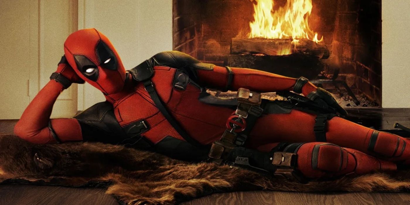 Deadpool poses in front of a fire