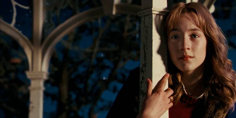 A close-up of Saoirse Ronan, leaning against a beam of a gazebo, in The Lovely Bones
