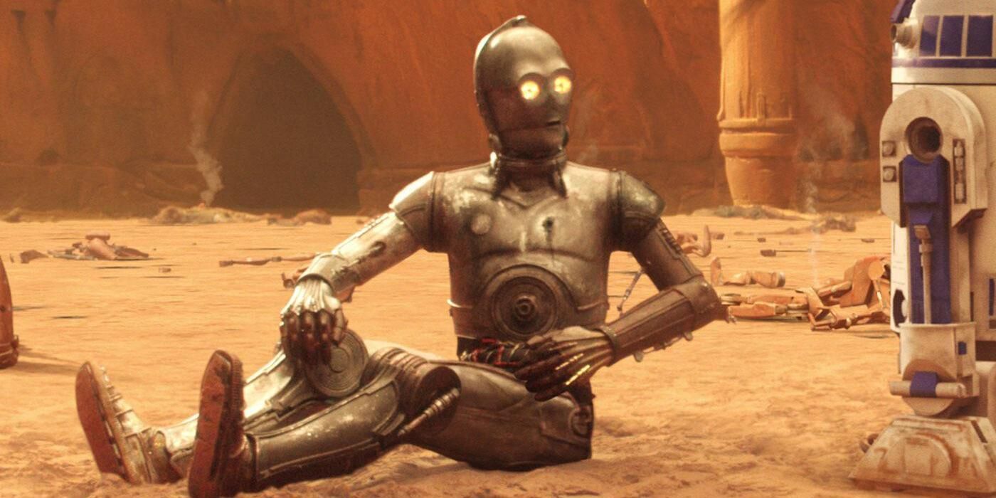 C-3PO sits on a rocky surface next to R2D2 in Star Wars: Attack of the Clones