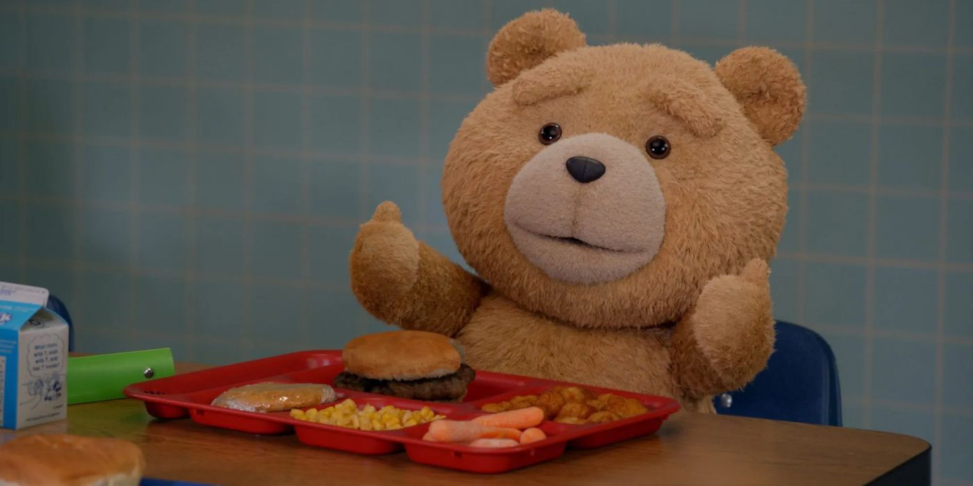 Ted gives thumbs up as he sits with his lunch tray in the Ted prequel show