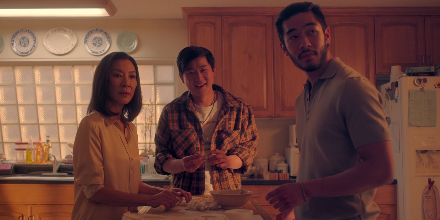 Michelle Yeoh as Mama, Sam Song Li as Bruce, and Justin Chien as Charles stand in the kitchen in The Brothers Sun