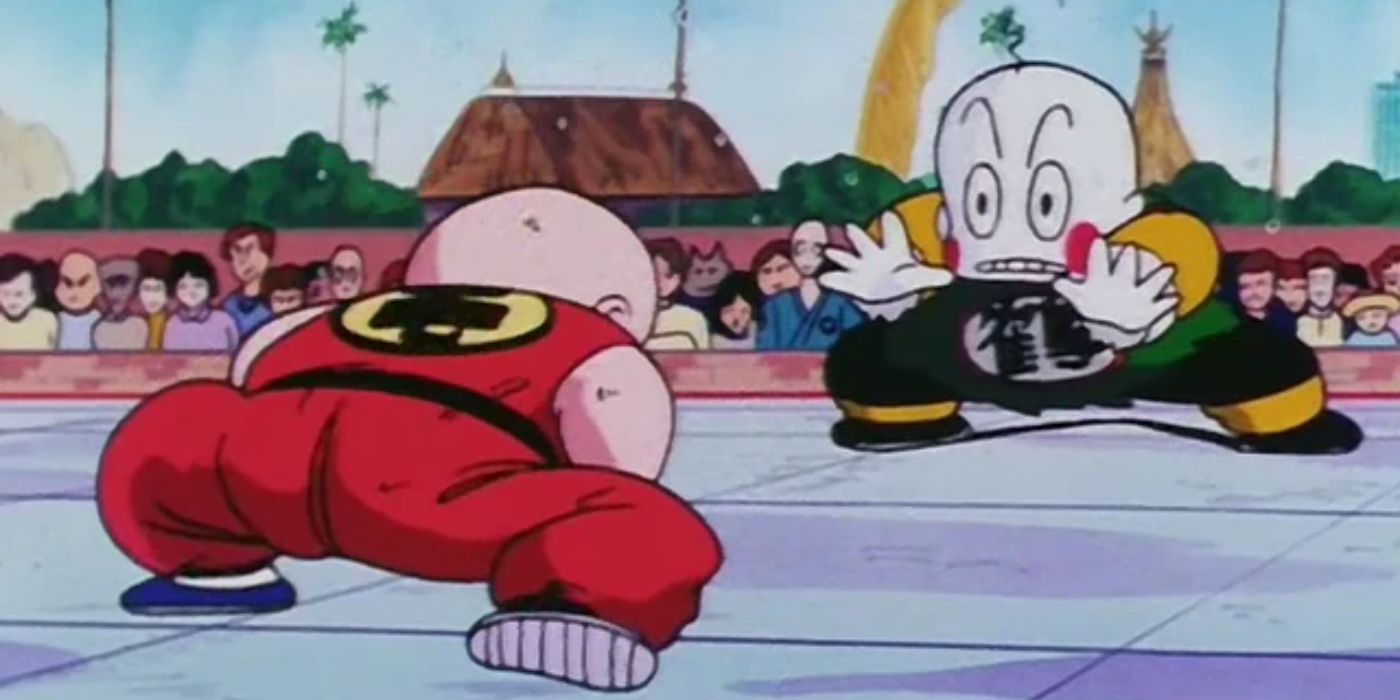 Two bald-headed anime characters prepare to fight in front of an audience
