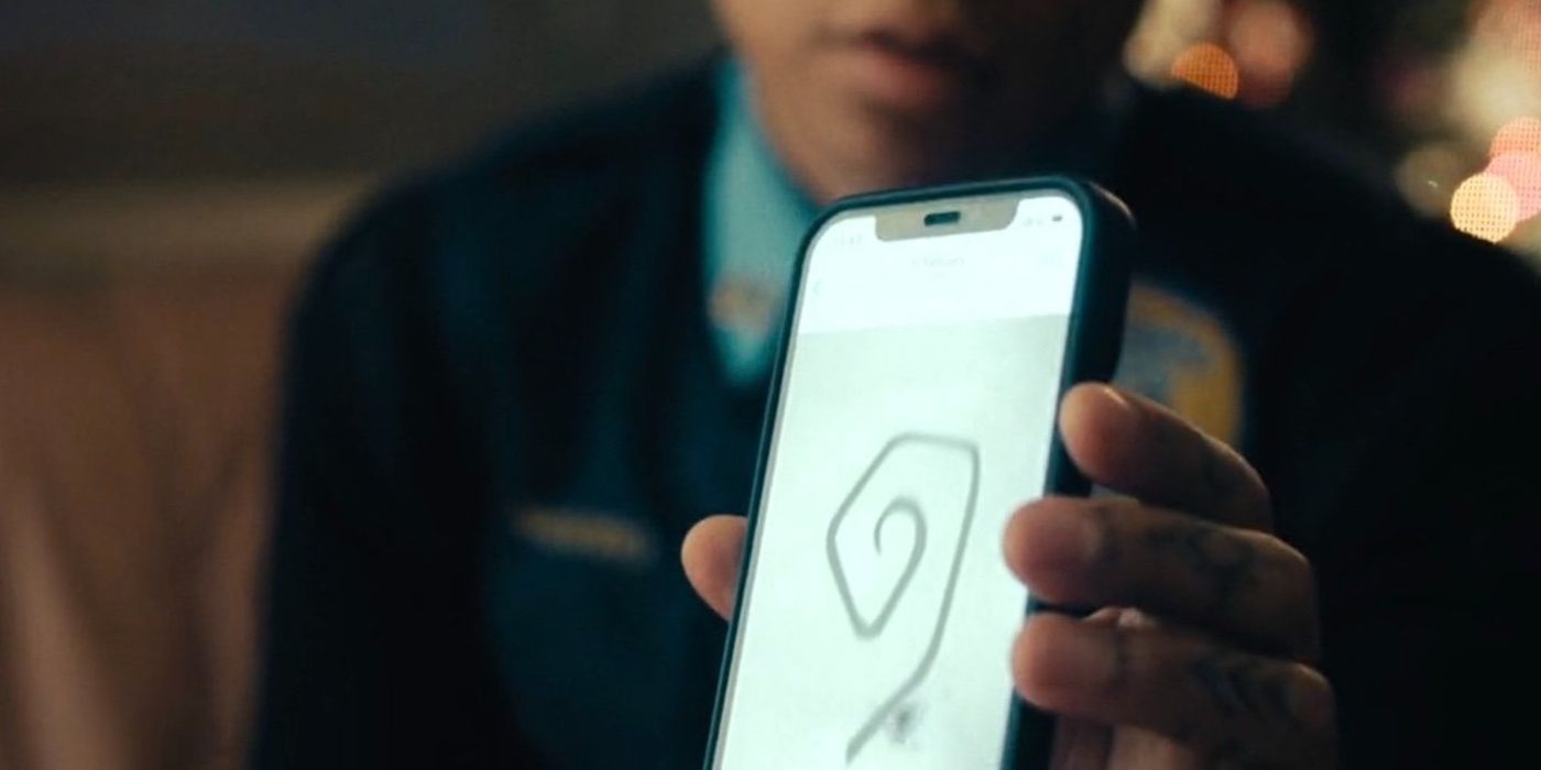 Kali Reis as Navarro shows her phone with the spiral in True Detective
