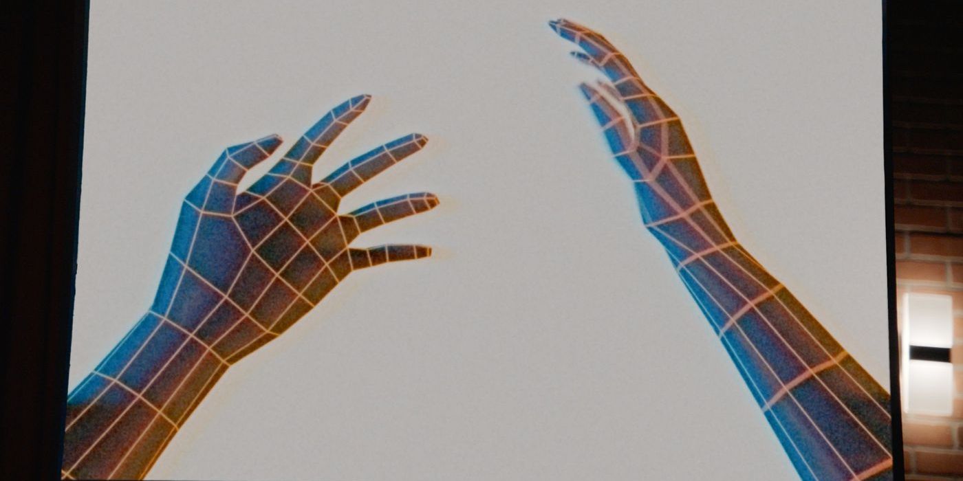 A screen shows two hand and arms