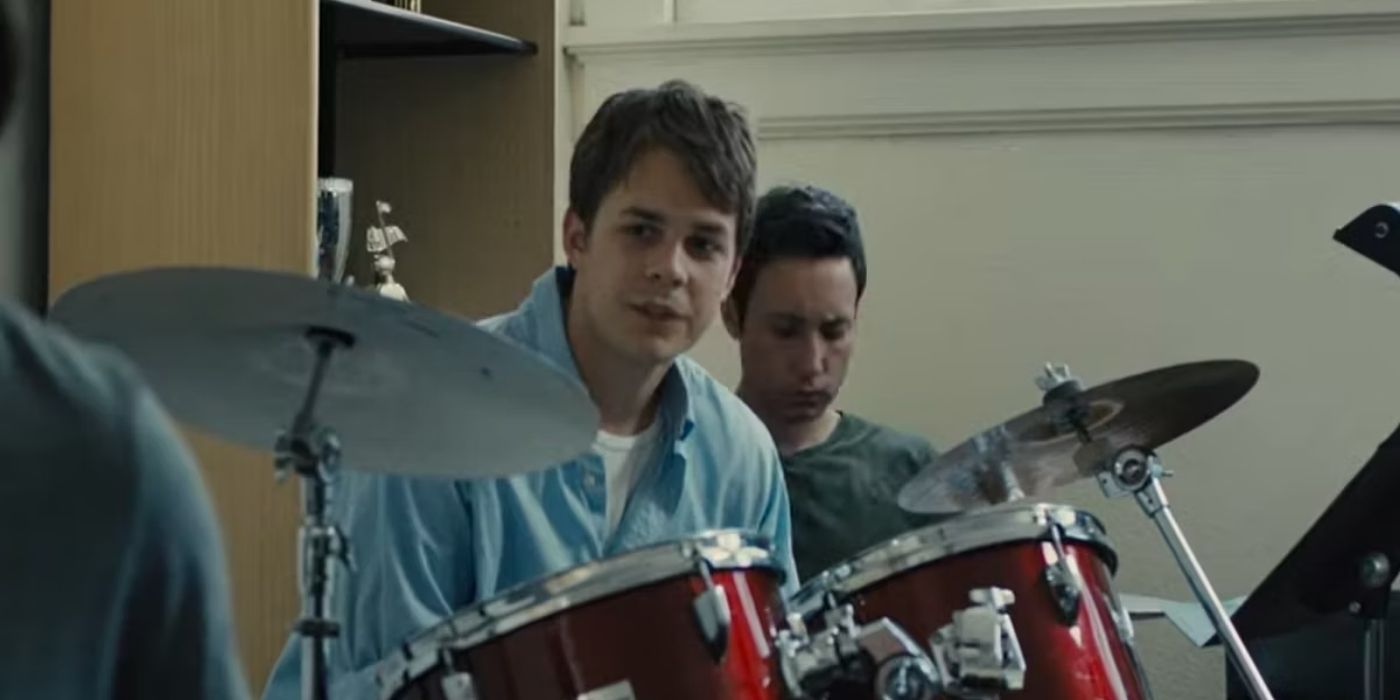 A young man sits at a drum kit in the short film Whiplash (2013)