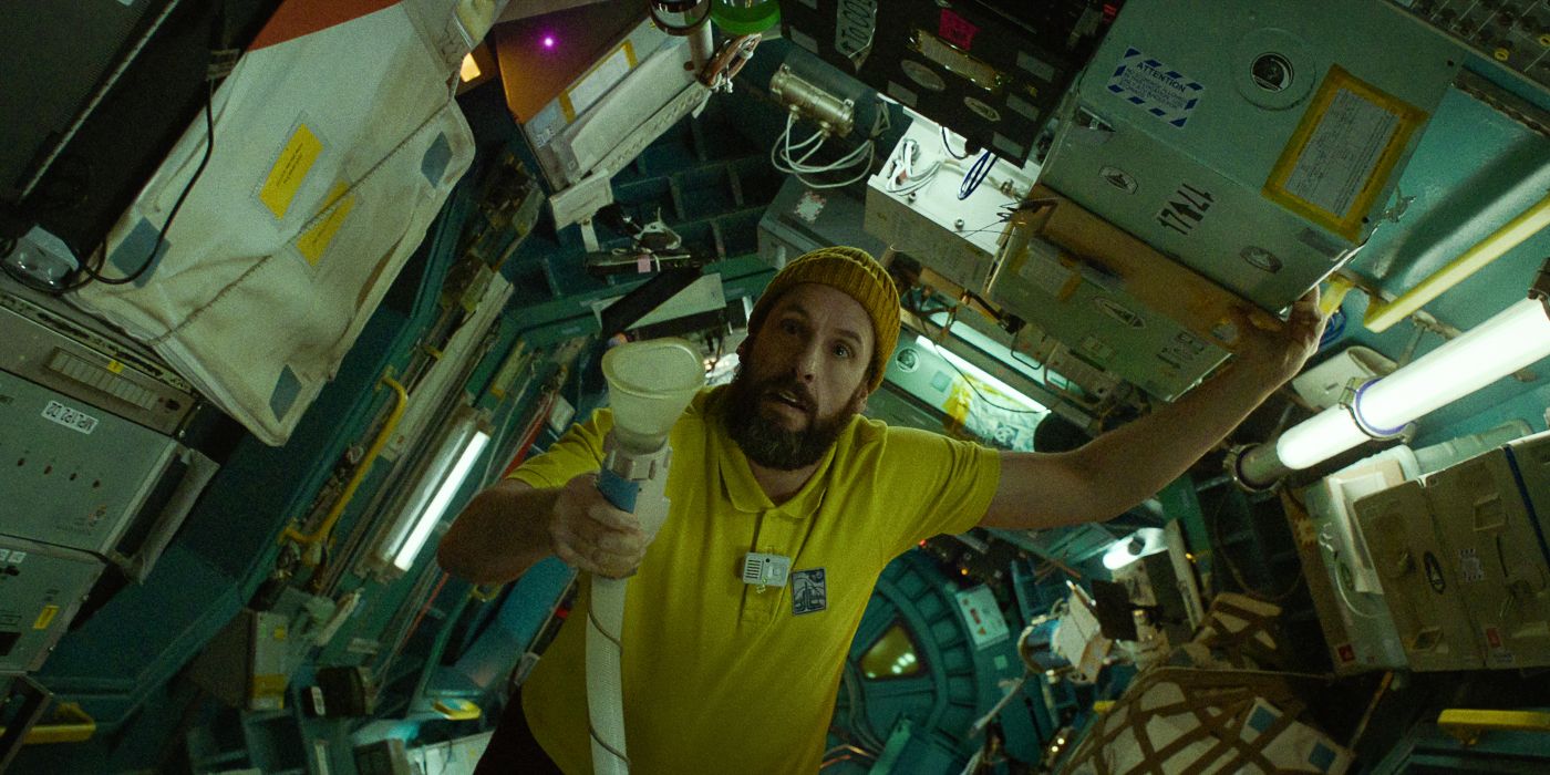 Adam Sandler as Jakub wearing a yellow collared shirt on the space station in Spaceman
