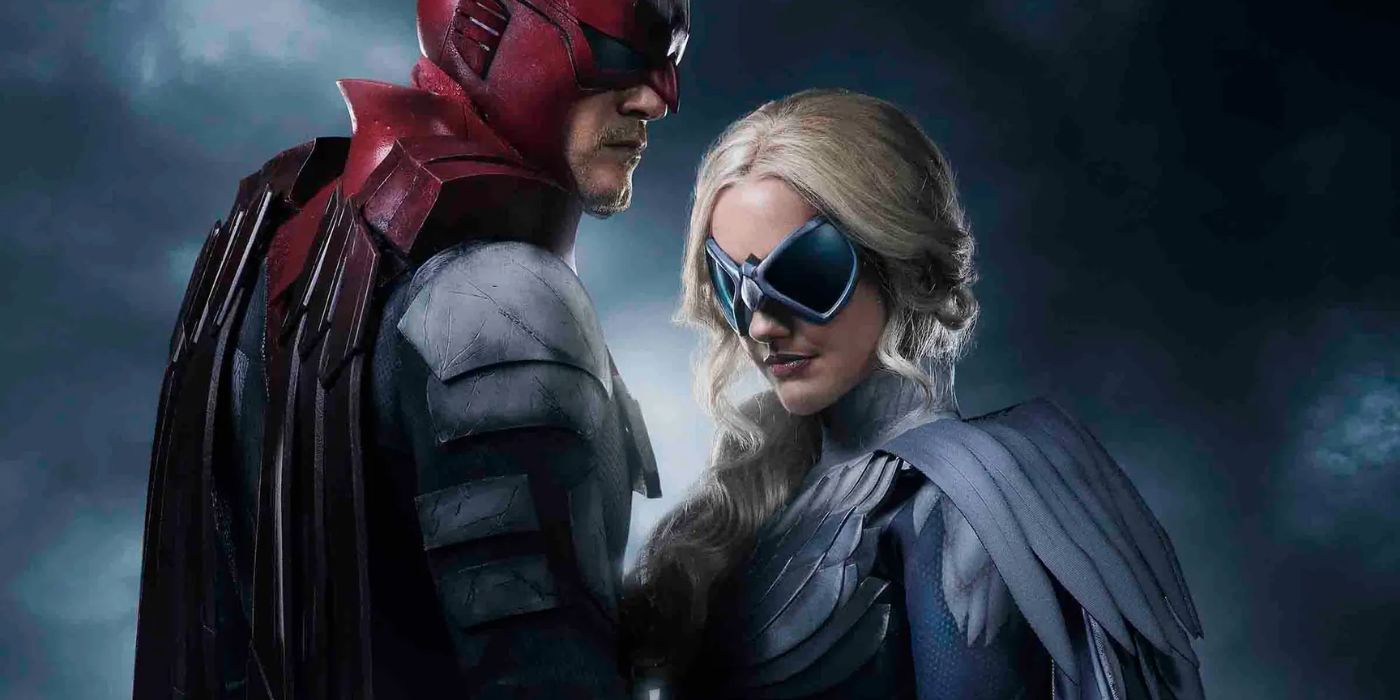 Alan Ritchson as Hawk standing with another woman in their superhero costumes in Titans
