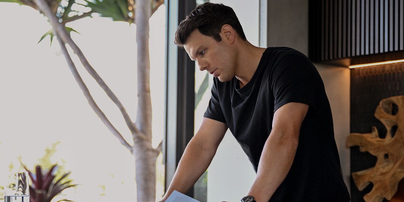 Apples Never Fall actor Jake Lacy as Troy Delaney standing on a balconey looking over the edge