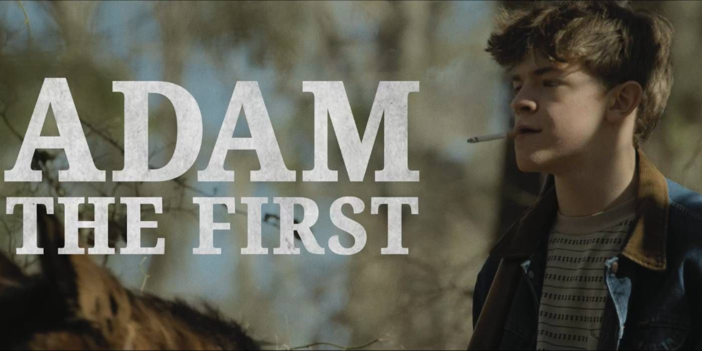 Oakley Fegley as Adam smoking a cigarette in the woods wearing a dark navy jacket in Adam the First 
