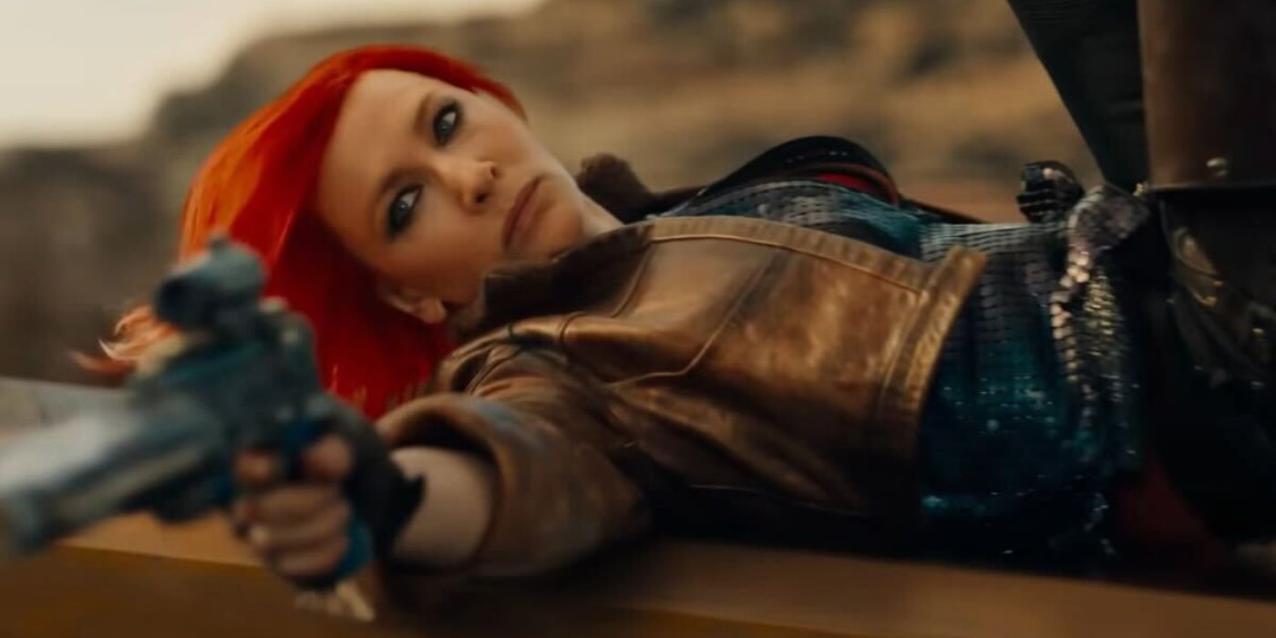 Cate Blanchett as Lilith shooting a gun while sliding on her back in Borderlands