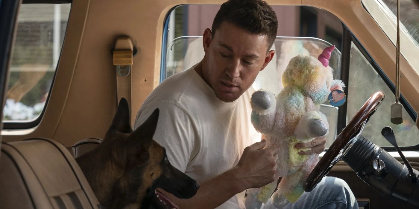 Channing Tatum in a car with a dog and holding a stuffed animal as Jackson Briggs in Dog